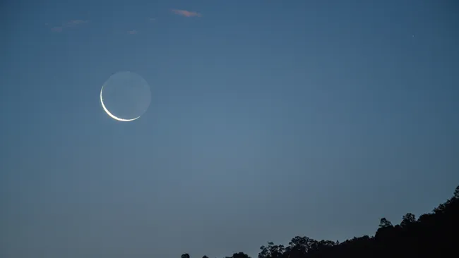 Crescent Moon Aligns with Jupiter and Earthshine Illuminates the Sky on July 23